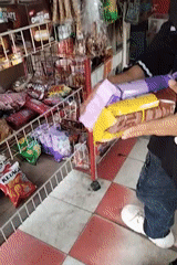 Everyday scenes from a small Indonesian town — shops, construction, repairs