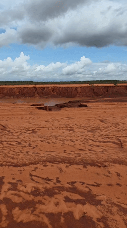 Dry red riverbed with puddles documented in Mui Ne