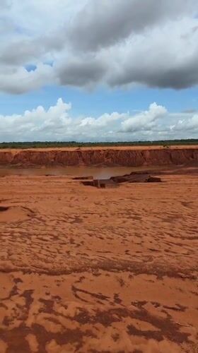 Dry red riverbed with puddles documented in Mui Ne
