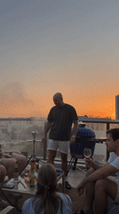 Sunset rooftop barbecue gathering documented in Tel-Aviv