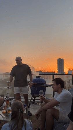 Sunset rooftop barbecue gathering documented in Tel-Aviv