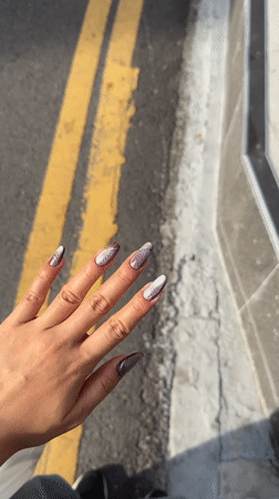 Person shows off nail art against street in Incheon