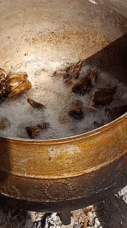 Outdoor deep frying activity documented in Gwagwalada, Nigeria