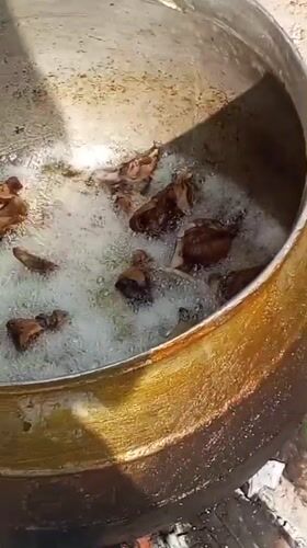 Outdoor deep frying activity documented in Gwagwalada, Nigeria