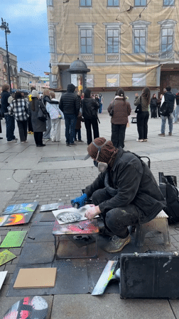 Street artist draws crowds during outdoor art demonstration in Saint Petersburg