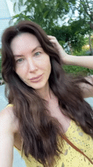 Woman in yellow top takes selfies across Vietnam ward
