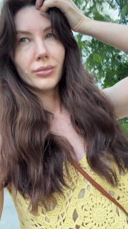 Woman in yellow top takes selfies across Vietnam ward