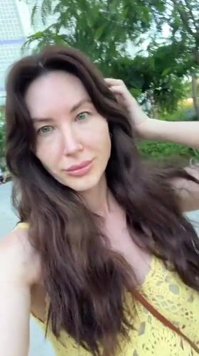Woman in yellow top takes selfies across Vietnam ward