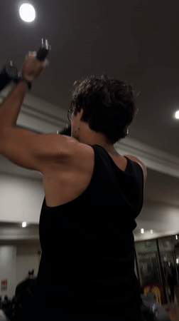 Man performs pull-ups at Denpasar gym early morning