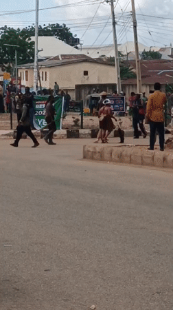 Horses, crowds, and street activity in Bukuru, Nigeria