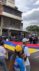 Teachers and supporters march through Caracas streets with Venezuelan flags