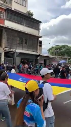 Teachers and supporters march through Caracas streets with Venezuelan flags