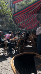 Milan cafe patrons enjoy sunny spring morning outdoors