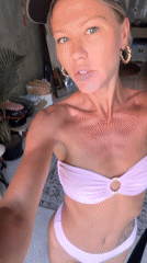 Woman takes selfie videos in bikini indoors, North Kuta