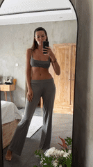 Woman takes mirror selfies in gray sportswear, North Kuta