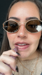 Woman applies lip gloss in car on Mexico street