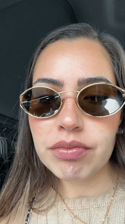 Woman applies lip gloss in car on Mexico street