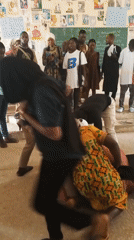 Dozen witnesses observe two women on floor in room