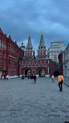 Pedestrians gather at historic red building in Khimki