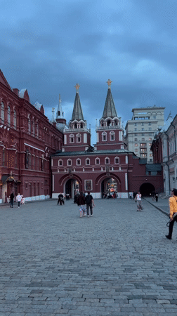 Pedestrians gather at historic red building in Khimki