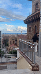 Couple enjoys Barcelona cityscape view from elevated stone building