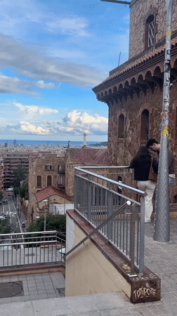 Couple enjoys Barcelona cityscape view from elevated stone building
