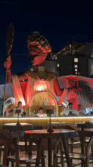 Rooftop bar night in Himarë, Albania, statue and cocktails