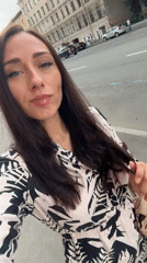 Black Mustang parked as selfies happen nearby in Saint Petersburg