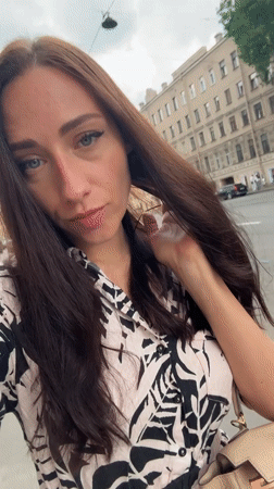Black Mustang parked as selfies happen nearby in Saint Petersburg