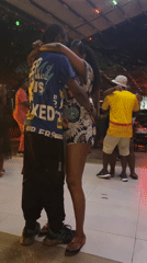Couples dance at outdoor nighttime venue in Accra, Ghana