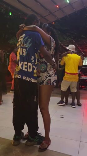 Couples dance at outdoor nighttime venue in Accra, Ghana