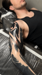 Man gets tattoo work done at Moscow studio
