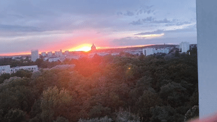 Potsdam skyline glows at sunset behind a domed landmark