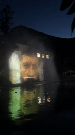 Building projection display reflects in water feature in Vratsa