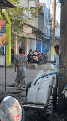 Morning street traffic and vendors across Larangan, Indonesia
