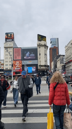 Pedestrians cross street near Buenos Aires Obelisk