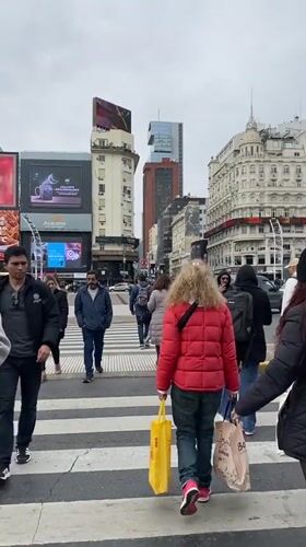 Pedestrians cross street near Buenos Aires Obelisk