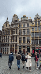Pedestrians and horse carriages populate Brussels' Grand Place square