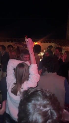 Evening social gathering documented in Lucignano, Italy courtyard