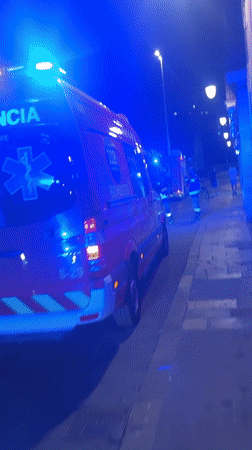 Emergency vehicles respond on a Barcelona street at night