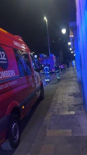 Emergency vehicles respond on a Barcelona street at night