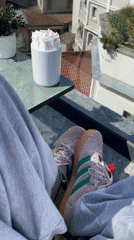 Person relaxes on Istanbul rooftop overlooking Galata Tower