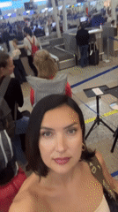 Woman films busy airport check-in area in Kuta