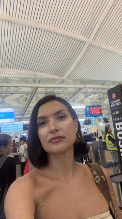 Woman films busy airport check-in area in Kuta