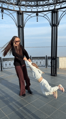 Woman and child play at Kamyshin waterfront gazebo