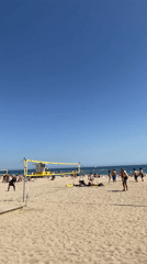 Beach volleyball activity observed in Barcelona under sunny skies