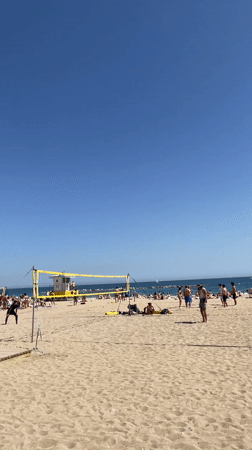 Beach volleyball activity observed in Barcelona under sunny skies