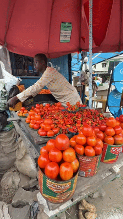 Market stalls and street traffic on a grey afternoon in Ado