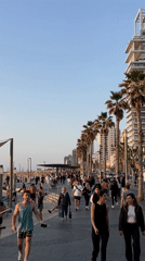 Ordinary afternoon unfolds along Tel Aviv's bustling beachfront promenade