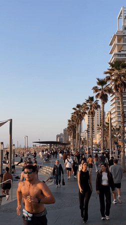 Ordinary afternoon unfolds along Tel Aviv's bustling beachfront promenade